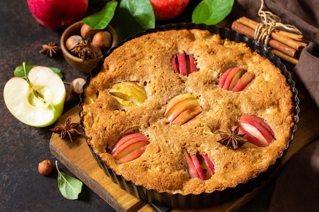 Apple baking seasonal Apple pie with hazelnut and cinnamon on a rustic wooden table