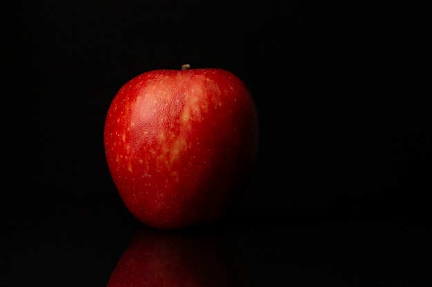 Apple on black background. Space for text.