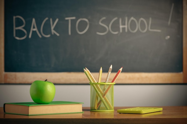 Apple on a book on blackboard background Education concept