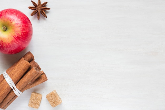 Apple, brown sugar and anise with cinnamon on a light background