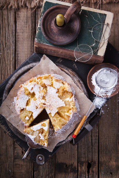 Apple cake on a vintage suitcase in powdered sugar