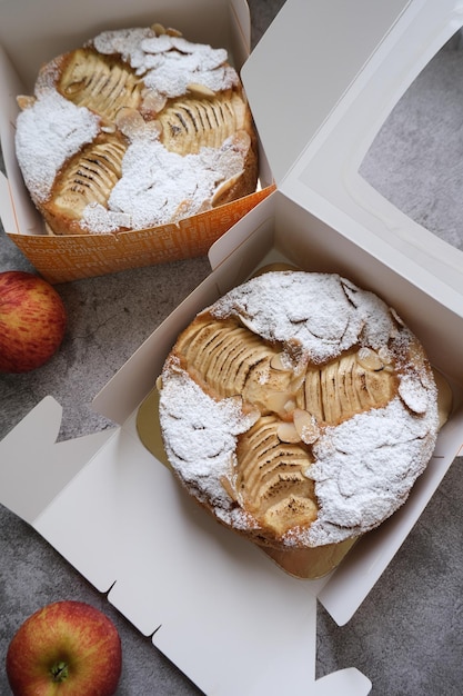 Apple cake with almond slices and icing sugar