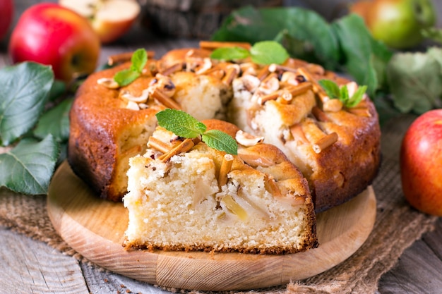 Apple cake with fresh fruits on wooden table