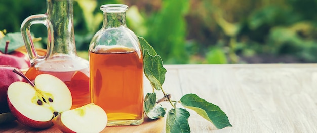 Apple cider vinegar in a bottle. Selective focus.