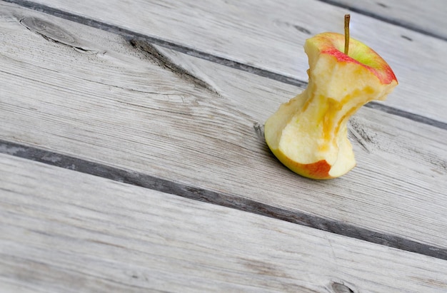 An apple core on a woodensurface