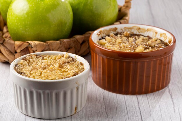 Apple crumble in ramekin on the table