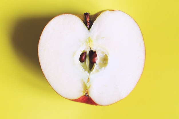 Photo apple cut on a yellow background