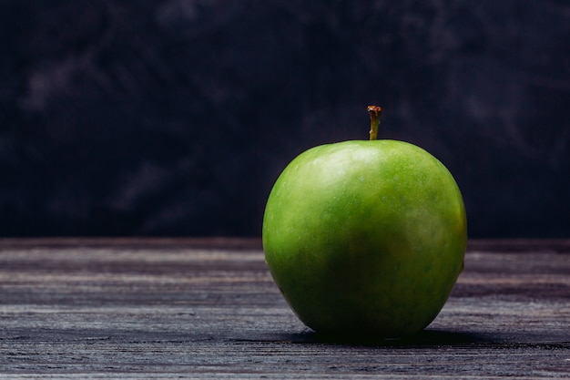 Apple green ripe on a wooden table