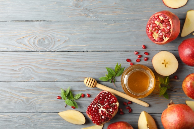 Apple, honey and pomegranate on wooden, top view. Home treatment