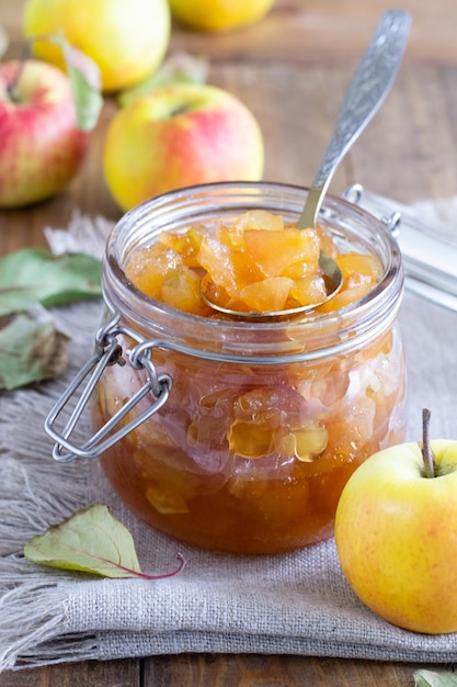 Apple jam in jar on wooden table