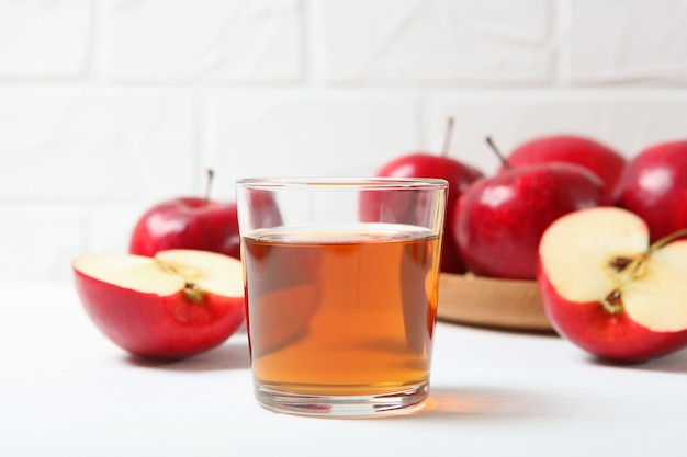 Apple juice from red apples on the table