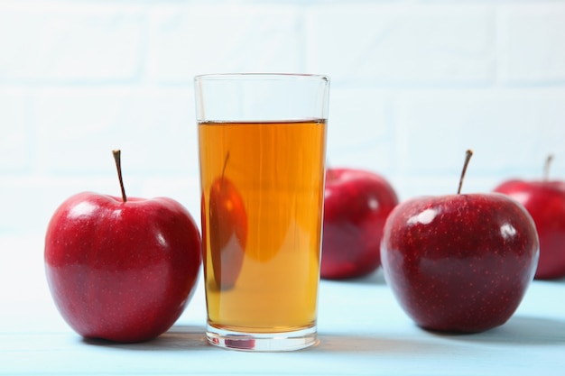 Apple juice from red apples on the table