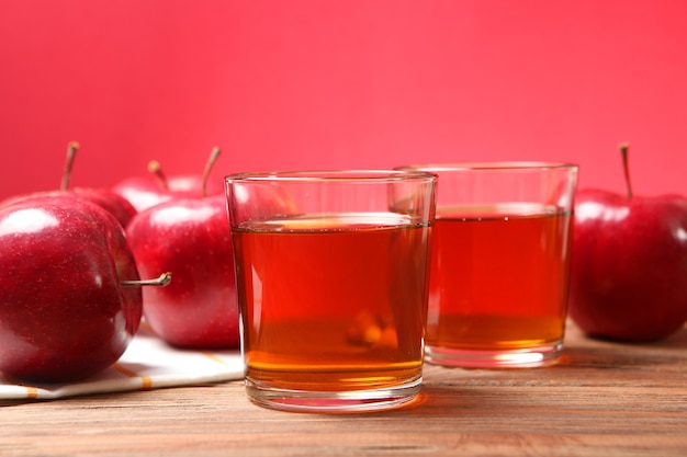 Apple juice from red apples on the table