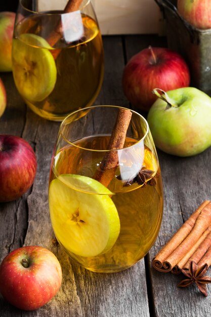 Apple juice in glass with cinnamon and anise