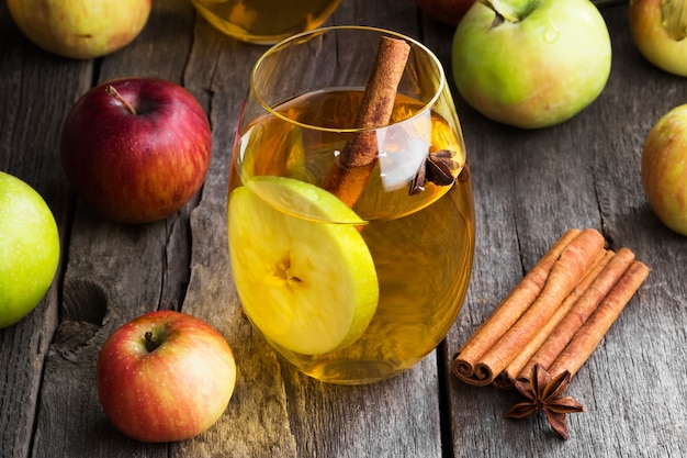 Apple juice in glass with cinnamon and anise