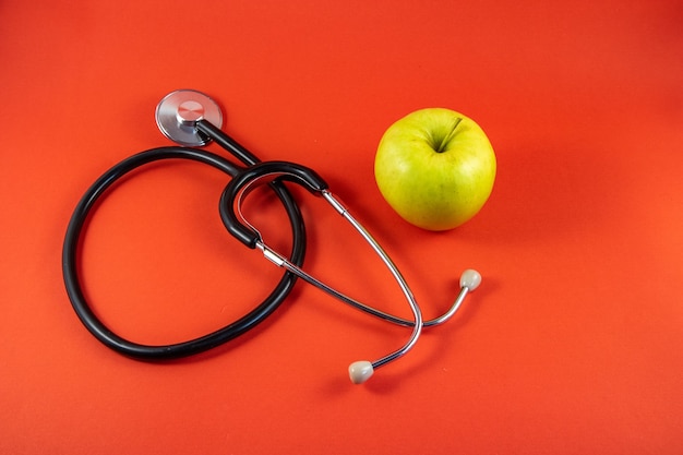 Photo apple next to a medical stethoscope