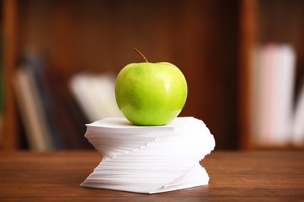 Apple and paper on table in the room