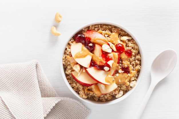 Apple peanut butter quinoa bowl with jam and cashew for healthy breakfast