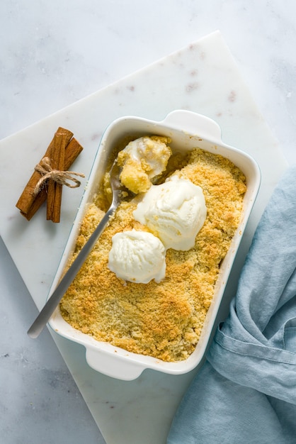 Apple and pear crumble with ice cream. top view vertical