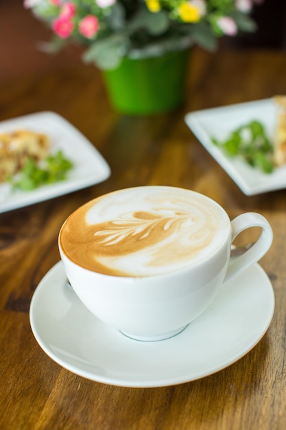 Apple pie and cappuccino on a wooden table