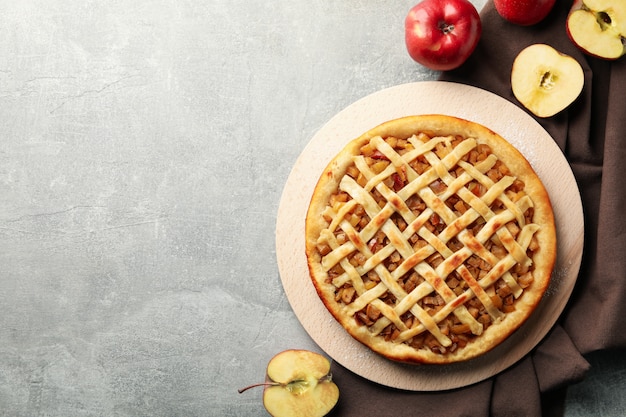 apple pie and ingredients on gray background