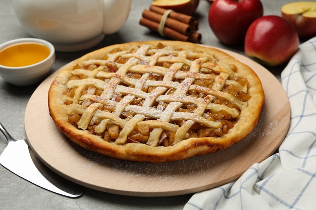 apple pie and ingredients on gray background
