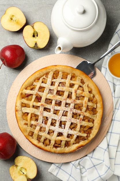 apple pie and ingredients on gray background