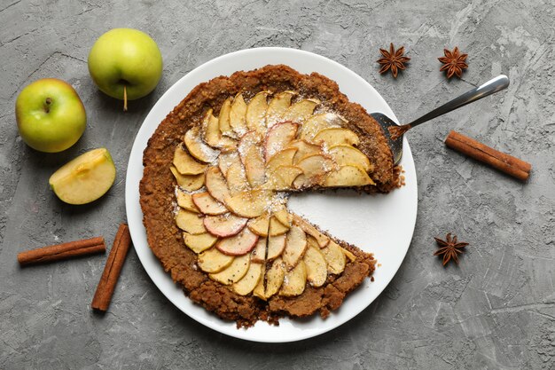 apple pie and ingredients on gray background