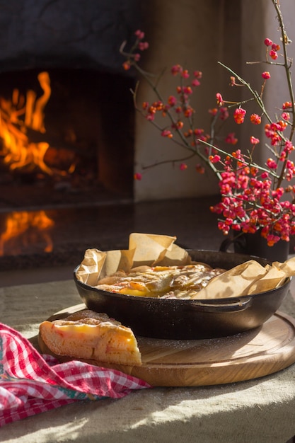 Apple pie is on the table by the oven