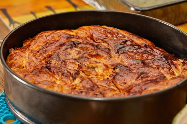 Apple pie in metal mold after baking in the oven