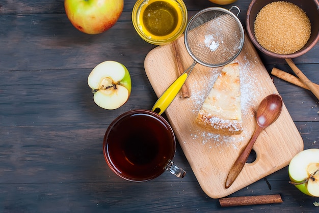 Apple pie and tea on a wooden table