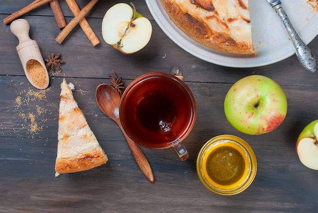 Apple pie and tea on a wooden table