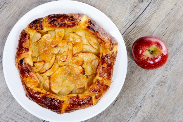 Apple pie on white plate on table