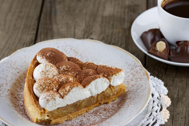 Apple pie with cream and a cup of hot chocolate