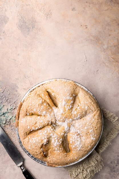 Apple pies and ingredients over stone