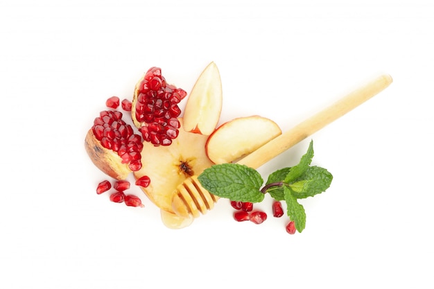 Apple, pomegranate and honey isolated on white. Natural treatment