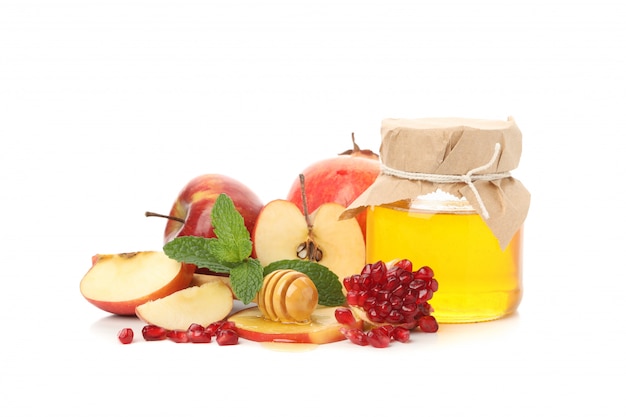 Apple, pomegranate and honey isolated on white.