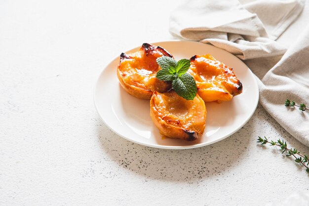 Apple quince baked with honey on a white plate with ice cream Healthy vegetarian dessert