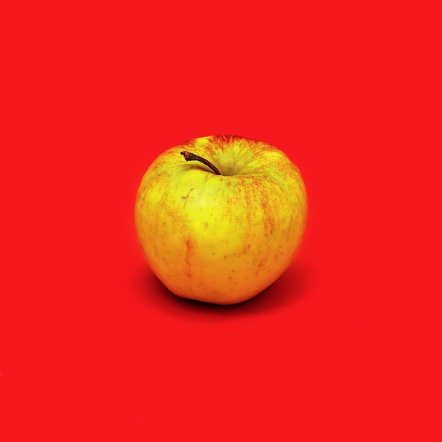 Apple on a red background. Minimal style