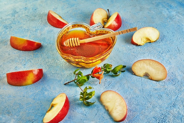 An apple shaped bowl with honey