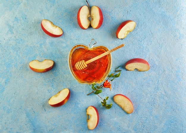 An apple shaped bowl with honey