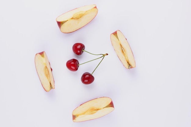 Apple slices and red berries isolated on white background Closeup of sweet fruits and berries Healthy food concept