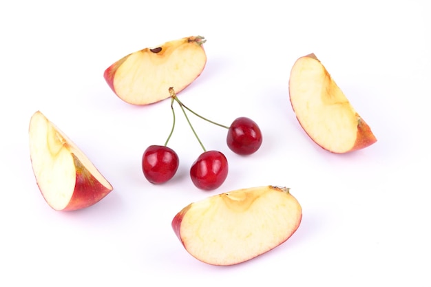 Apple slices and red berries isolated on white background Closeup of sweet fruits and berries Healthy food concept