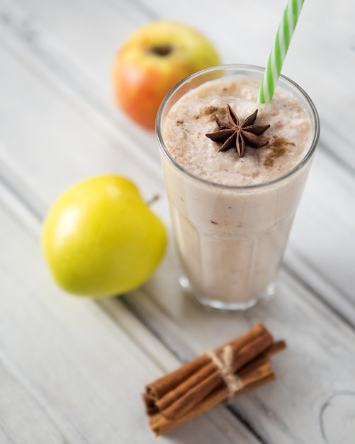 Apple smoothie in a glass with cinnamon