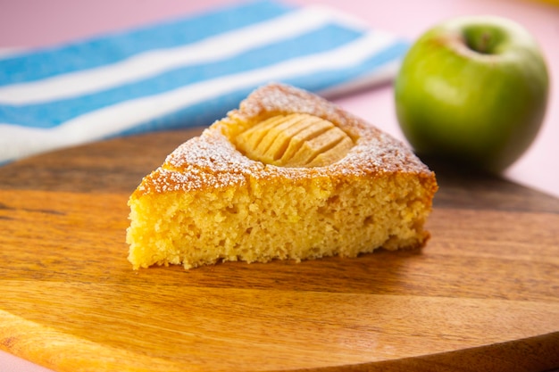 Apple sponge cake on a wooden plate.