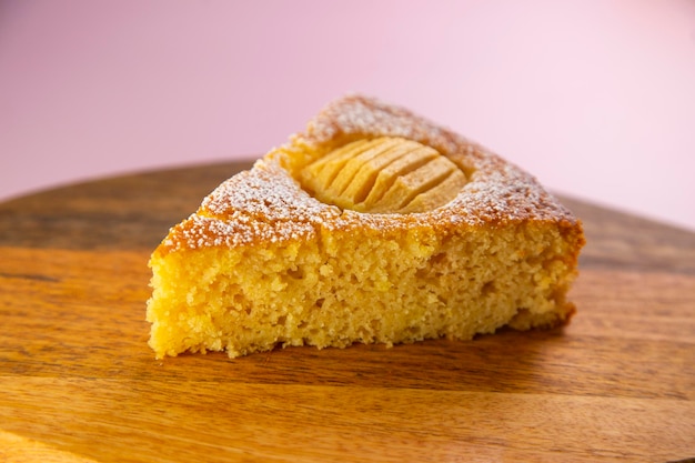 Apple sponge cake on a wooden plate.