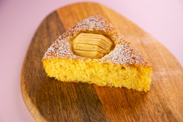 Apple sponge cake on a wooden plate.