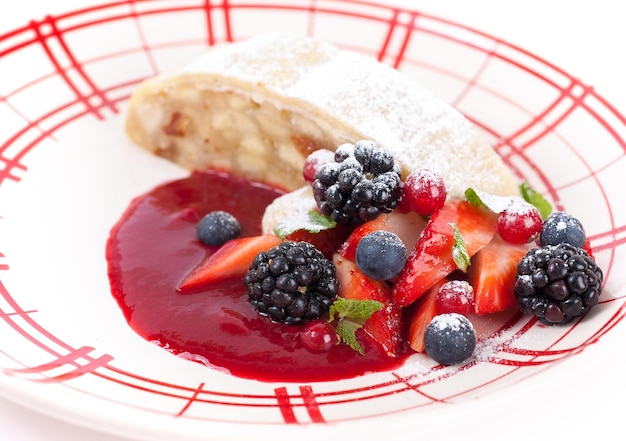 Apple strudel with sauce from fresh berries