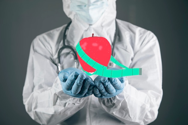 Apple with measuring tape diet concept doctor holding in his hand