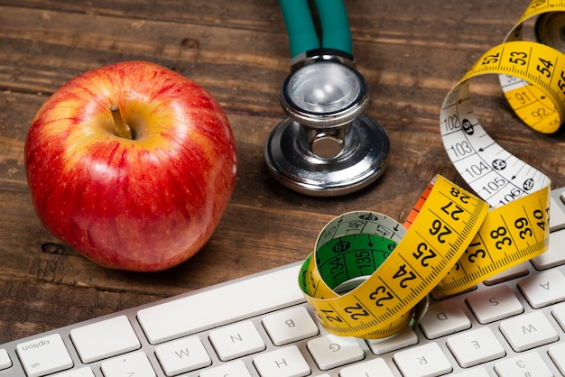 Photo apple with measuring tape, symbolizing overweight